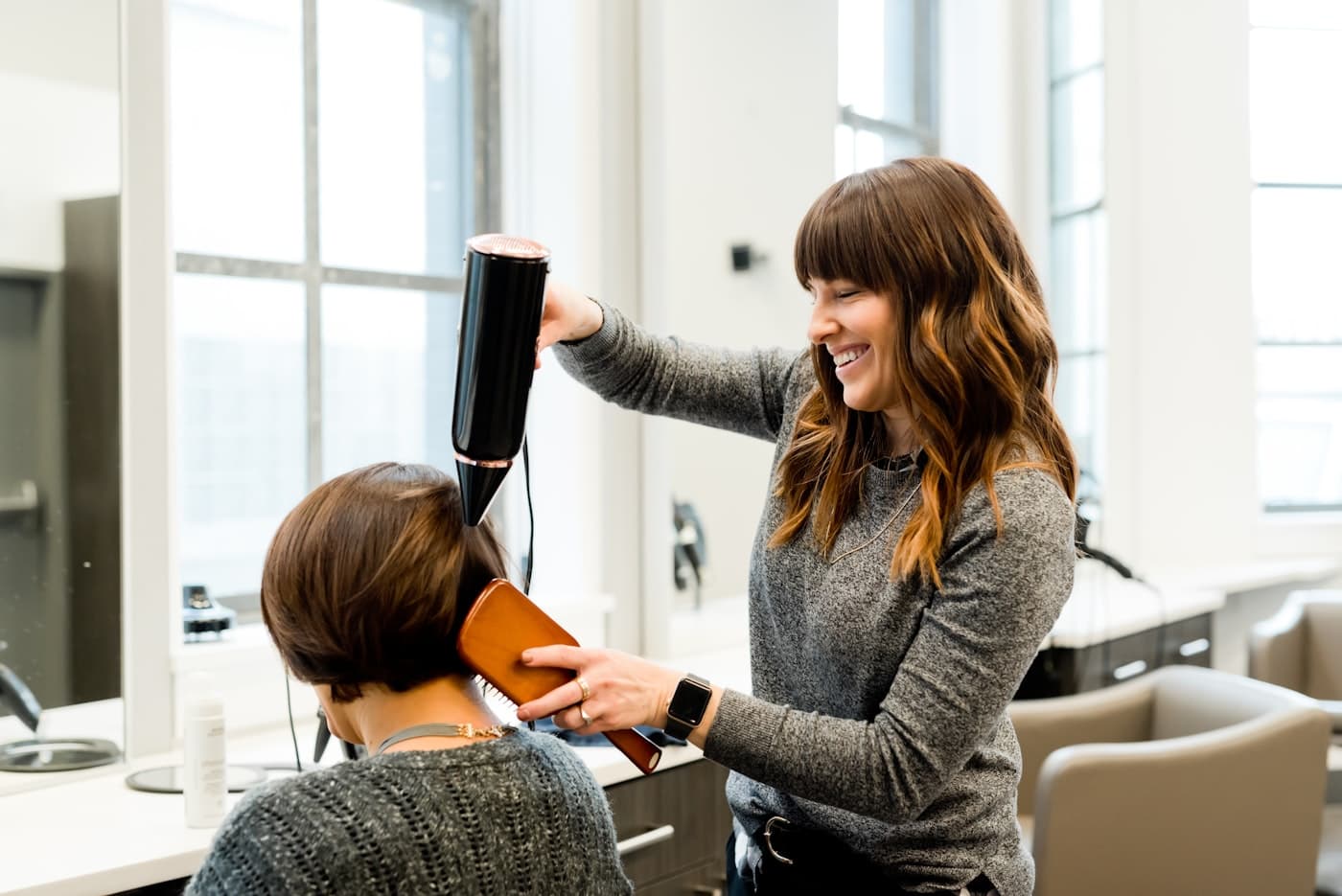A stylist finishing a blow-dry